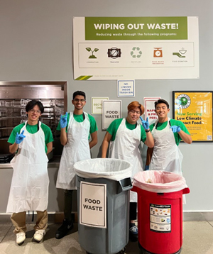 Group of employees near food waste bins for Wipe Out Waste event